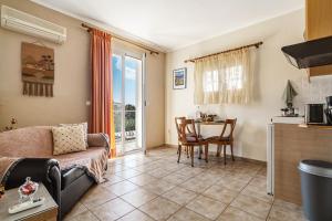 a living room with a couch and a table at Efrosyni apartment in Kefallonia