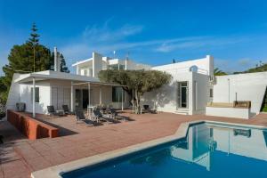 a house with a swimming pool in front of it at Can Lluc in Nuestra Señora de Jesus