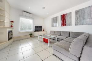 a living room with a couch and a tv at Can Lluc in Nuestra Señora de Jesus