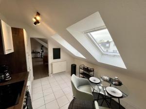 a living room with a table and chairs and a window at Ferienwohnung an der Aschaffaue in Aschaffenburg