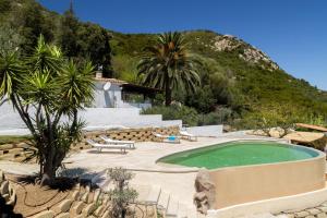 a swimming pool in a resort with a mountain at Villa Amata in Arzachena