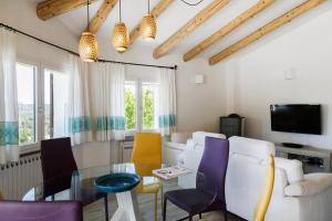 a living room with a table and chairs at Villa Amata in Arzachena