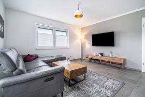 a living room with a couch and a flat screen tv at Seeglück 1 am Tollensesee in Groß Nemerow