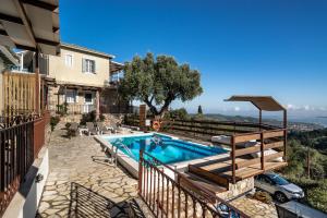 a swimming pool in a yard with a house at Afroksilia Villa Triantafilo in Lefkada