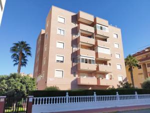 a tall building with palm trees in front of it at R-23 Modern apartment in La Mata in La Mata