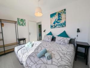 a bedroom with a large bed with blue pillows at R-23 Modern apartment in La Mata in La Mata +15 photos