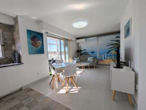 a kitchen and living room with a table and chairs at R-23 Modern apartment in La Mata in La Mata