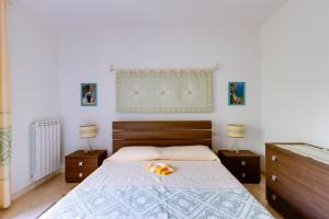 a bedroom with a large bed with two night stands at Casa Antonella sul Golf in S'archittu Cuglieri +18 photos