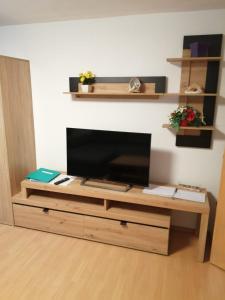 a wooden entertainment center with a flat screen tv at Ferienwohnung Mark in Biberwier