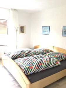 a bed with a comforter on it in a bedroom at Balver Aussicht in Balve