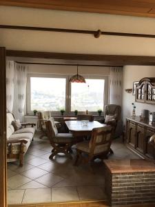 a living room with a table and chairs at Balver Aussicht in Balve