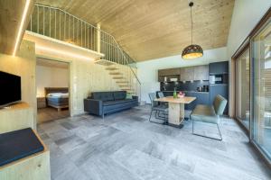a living room with a table and a couch at Pixnerhof Chalet Natyra in Kastelbell-Tschars