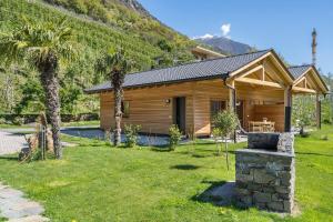 a log house with a pool in a yard at Pixnerhof Chalet Natyra in Kastelbell-Tschars