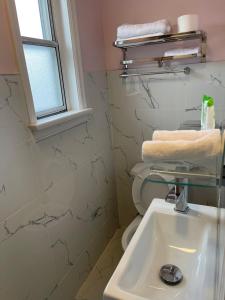 a bathroom with a sink and a toilet at Oshawa Inn Motel in Oshawa