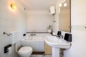 a bathroom with a toilet and a sink and a tub at Villa Grazia in Gallipoli +16 photos