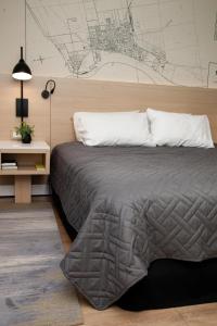 a bedroom with a bed and a drawing on the wall at Oshawa Inn Motel in Oshawa