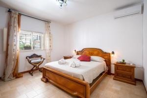a bedroom with a bed with two towels on it at Villa Grazia in Gallipoli