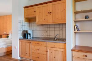 a kitchen with wooden cabinets and a sink at Aldeinerhof in Aldino +117 photos