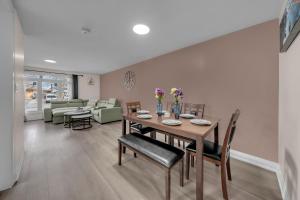a dining room and living room with a table and chairs at Poolside Paradise minutes away from the Falls in Thorold +31 photos
