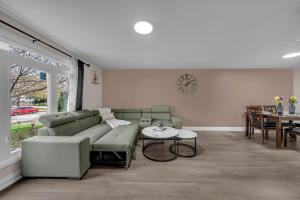 a living room with a couch and a table at Poolside Paradise minutes away from the Falls in Thorold