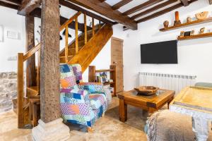 a living room with a tv and a chair at Casa Raymonde in Potes