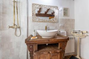 a bathroom with a sink and a shower with a mirror at Casa Raymonde in Potes +16 photos