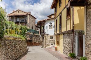 an alley in an old town with stone buildings at Casa Raymonde in Potes