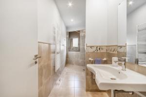 a white bathroom with a sink and a shower at El Paller de Cal Maso in Guisona +17 photos