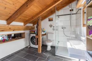 a bathroom with a shower and a tub and a toilet at Ferienwohnung Parzinger in Chieming +21 photos