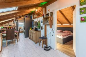 a kitchen and living room with a bed and a table at Ferienwohnung Parzinger in Chieming