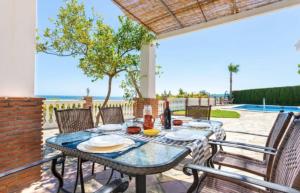 a dining table on a patio with a view of the ocean at Casa El Retiro in Nerja