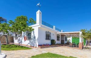 a white house with a cross on the roof at Casa El Retiro in Nerja