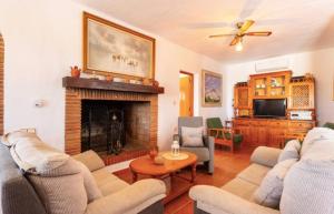 a living room with two couches and a fireplace at Casa El Retiro in Nerja