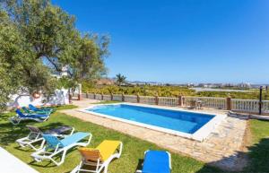 a backyard with a swimming pool and lounge chairs at Casa El Retiro in Nerja +13 photos