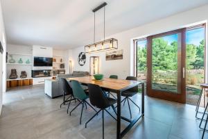 a dining room and living room with a table and chairs at Can Xumeu Ferrer in La Mola