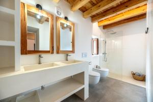 a bathroom with a sink and a toilet at Can Xumeu Ferrer in La Mola +20 photos