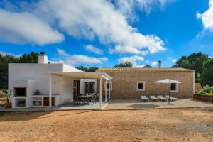 a house in the middle of a dirt field at Can Xumeu Ferrer in La Mola