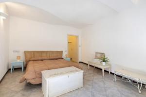 a bedroom with a large bed and two tables at Al Castello Residenza D'Epoca in Pietra Ligure