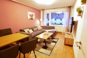 a living room with a couch and a table at Pension Haus Linden in Winterberg