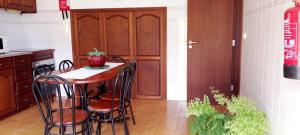 a kitchen with a table and chairs in a kitchen at Vivenda Chã in Ribeira Funda