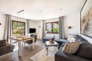 a living room with a couch and a table at Ostseekind in Timmendorfer Strand