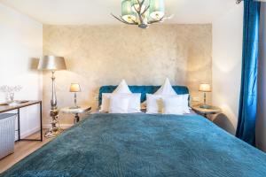 a bedroom with a blue bed with white pillows at Ostseekind in Timmendorfer Strand