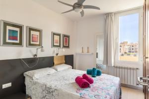 a bedroom with a bed with two towels on it at Apartamento Llenaire cerca playa in Port de Pollensa +21 photos