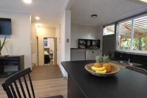 a kitchen with a table with a bowl of fruit on it at Mai 'Uta Experience in Hanga Roa +38 photos