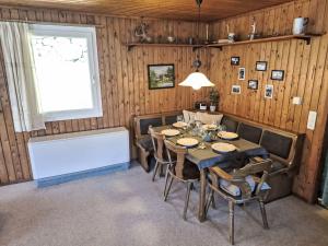 a dining room with a table and chairs and a window at Apartment Crap Grisch by Interhome in Ruschein +54 photos