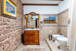 a stone bathroom with a sink and a toilet at Casa Retiro Vilafames in Vilafamés +22 photos
