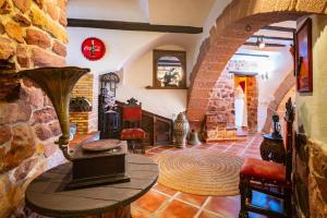 a living room with a table and a stone wall at Casa Retiro Vilafames in Vilafamés