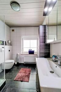 a bathroom with a tub and a toilet and a sink at Apartment by Interhome in Uslar +12 photos