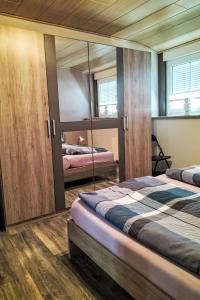 a bedroom with two beds and a mirror at Apartment by Interhome in Uslar