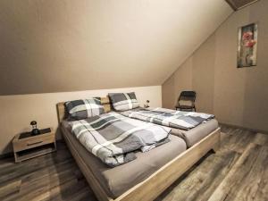 a bedroom with a large bed with two pillows at Apartment by Interhome in Uslar